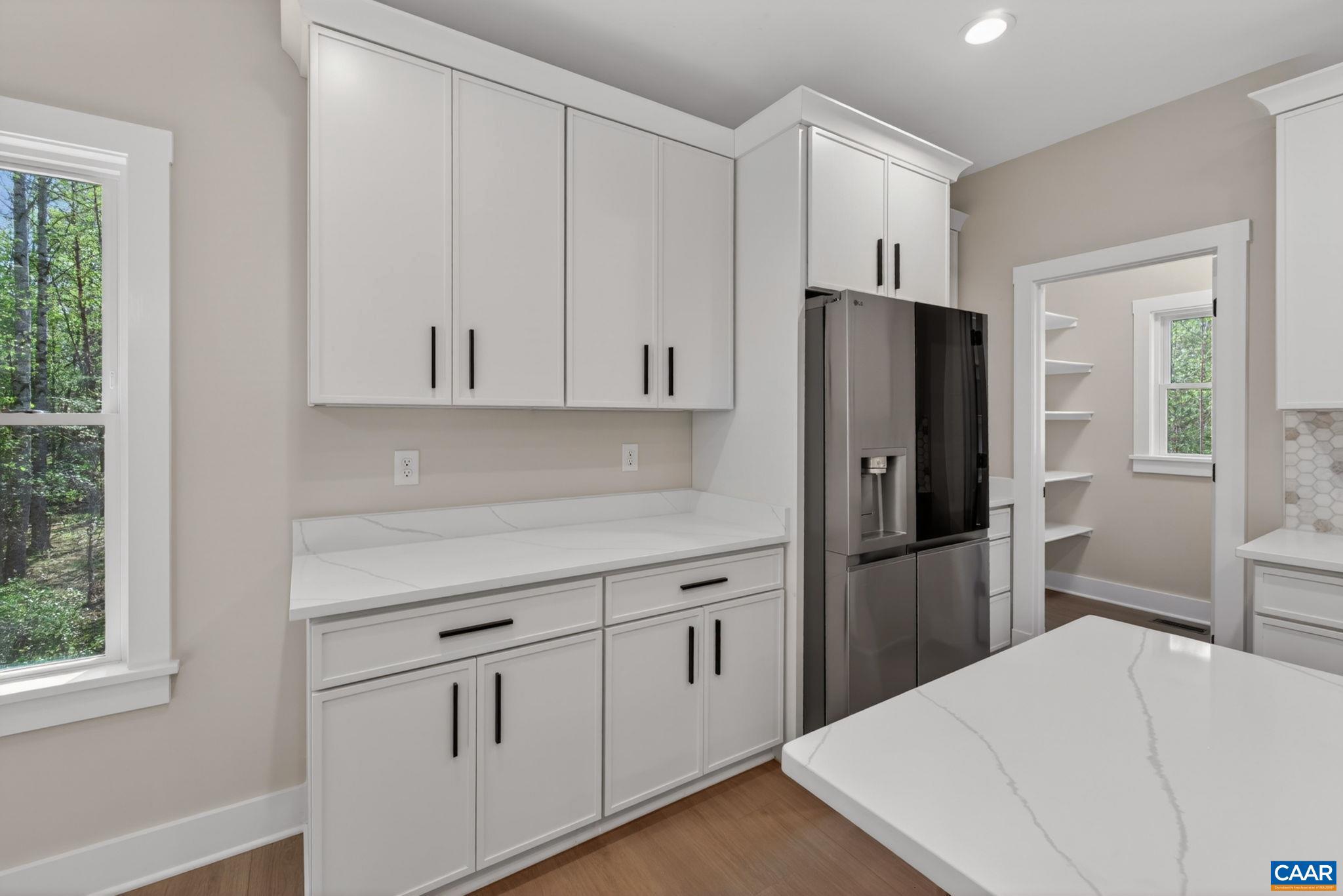 236 Palmer Place Ruckersville, VA 22968 - Photo 19 of 65 a kitchen with white cabinets and refrigerator