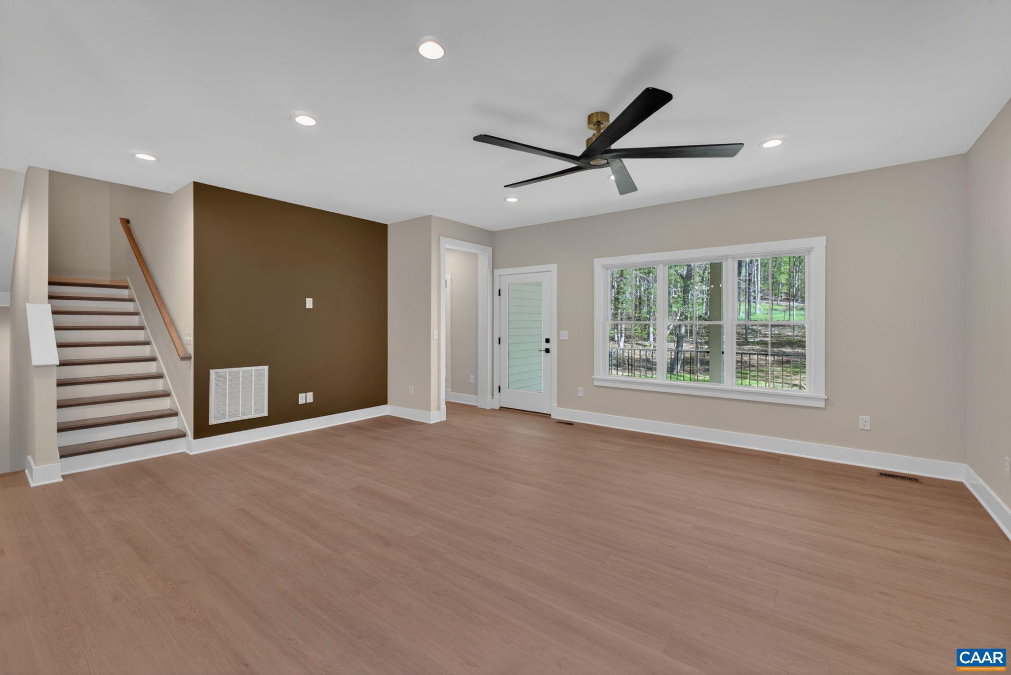 236 Palmer Place Ruckersville, VA 22968 - Photo 20 of 65 a view of an empty room with a window and wooden floor