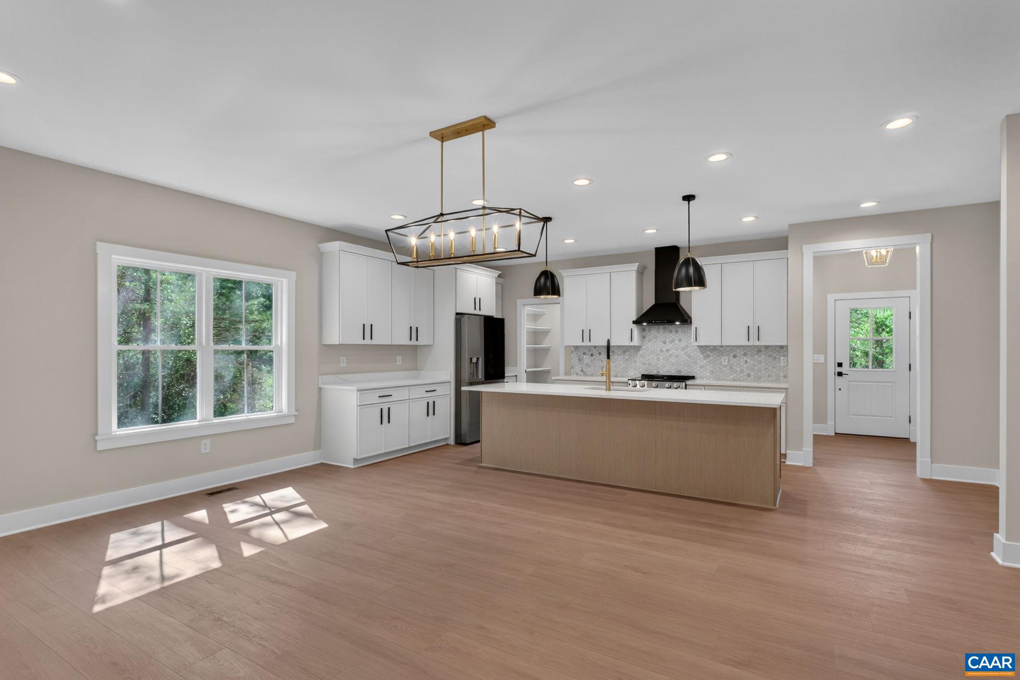 236 Palmer Place Ruckersville, VA 22968 - Photo 21 of 65 a large white kitchen with a large window appliances and cabinets