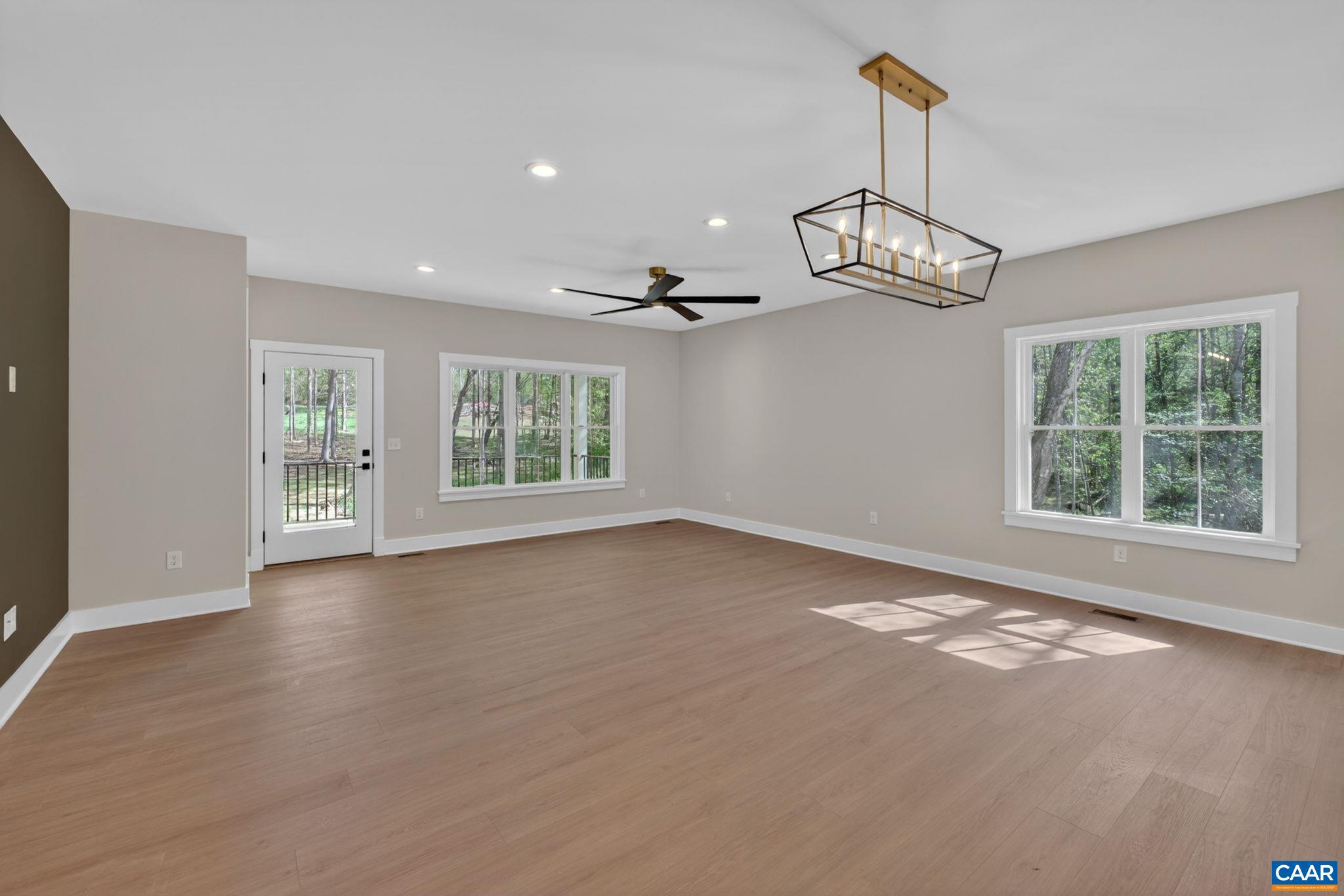 236 Palmer Place Ruckersville, VA 22968 - Photo 24 of 65 a view of an empty room with wooden floor and a window