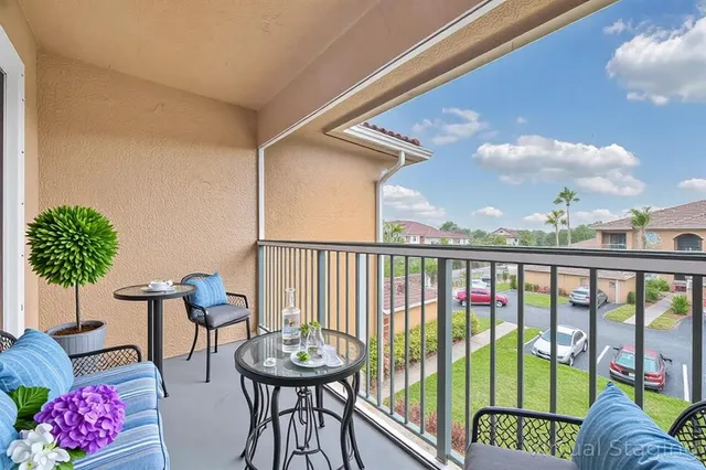a view of a balcony furniture and potted plants