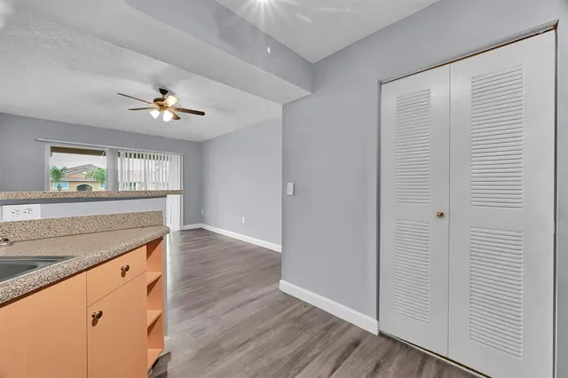 a view of cabinets with wooden floor and window