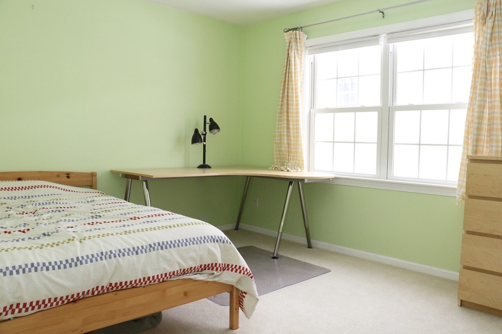 124 Maple Street, Unit 124 Needham, MA 02492 - Photo 11 of 16 a room with a bed and a window