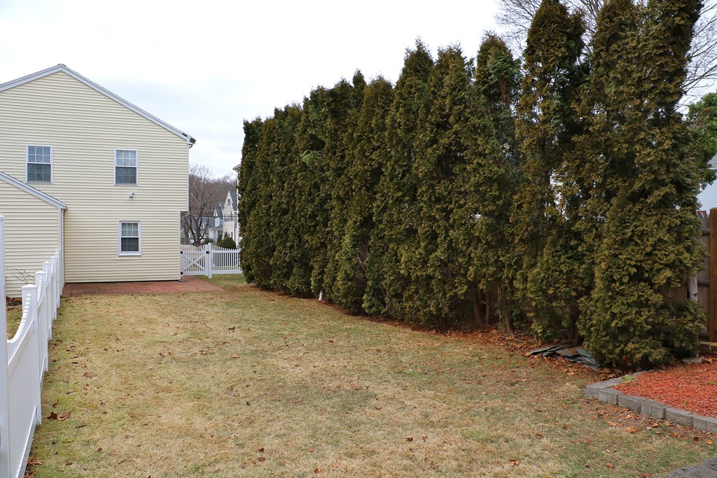 124 Maple Street, Unit 124 Needham, MA 02492 - Photo 16 of 16 a view of a backyard of the house