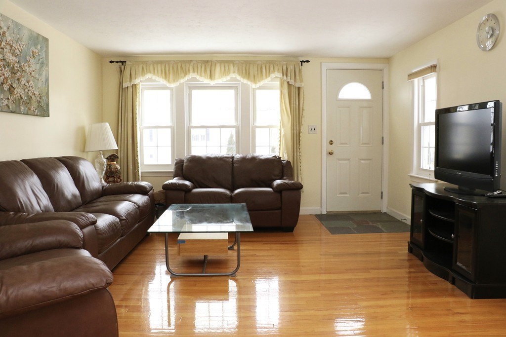 124 Maple Street, Unit 124 Needham, MA 02492 - Photo 3 of 16 a living room with furniture and a flat screen tv