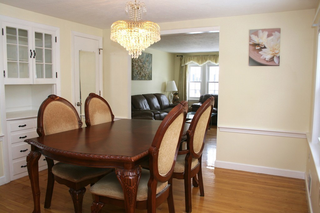 124 Maple Street, Unit 124 Needham, MA 02492 - Photo 4 of 16 a view of a dining room with furniture and chandelier