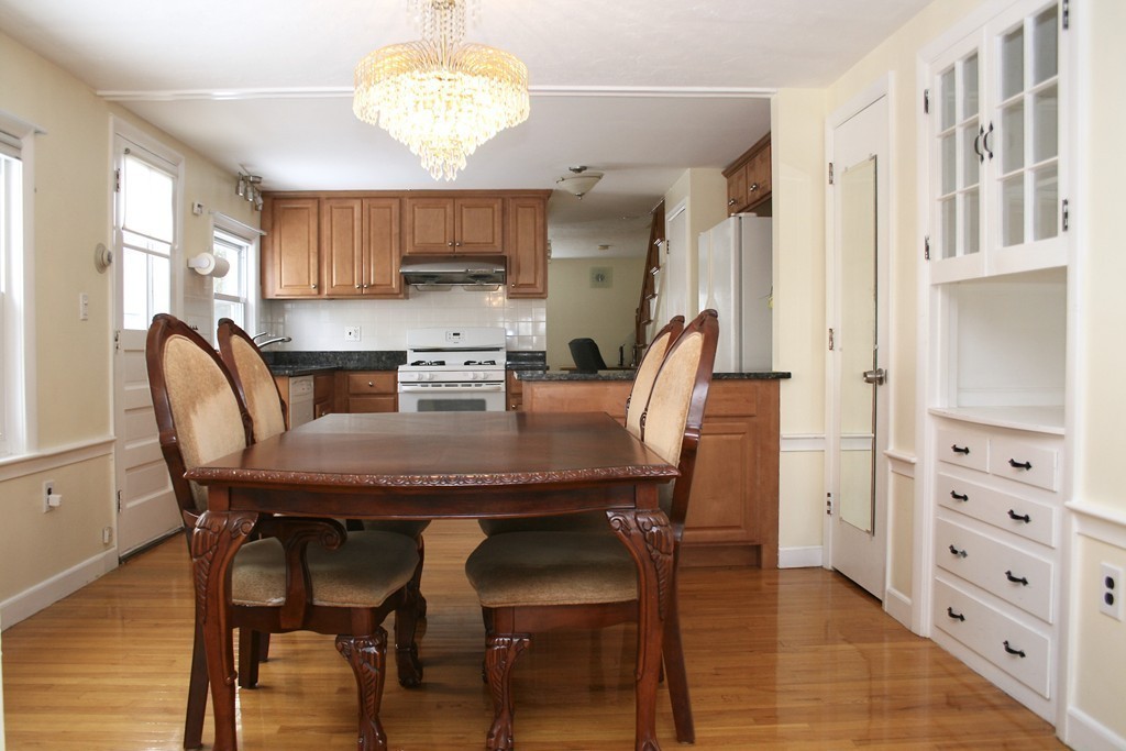 124 Maple Street, Unit 124 Needham, MA 02492 - Photo 5 of 16 a view of a dining room with furniture and wooden floor