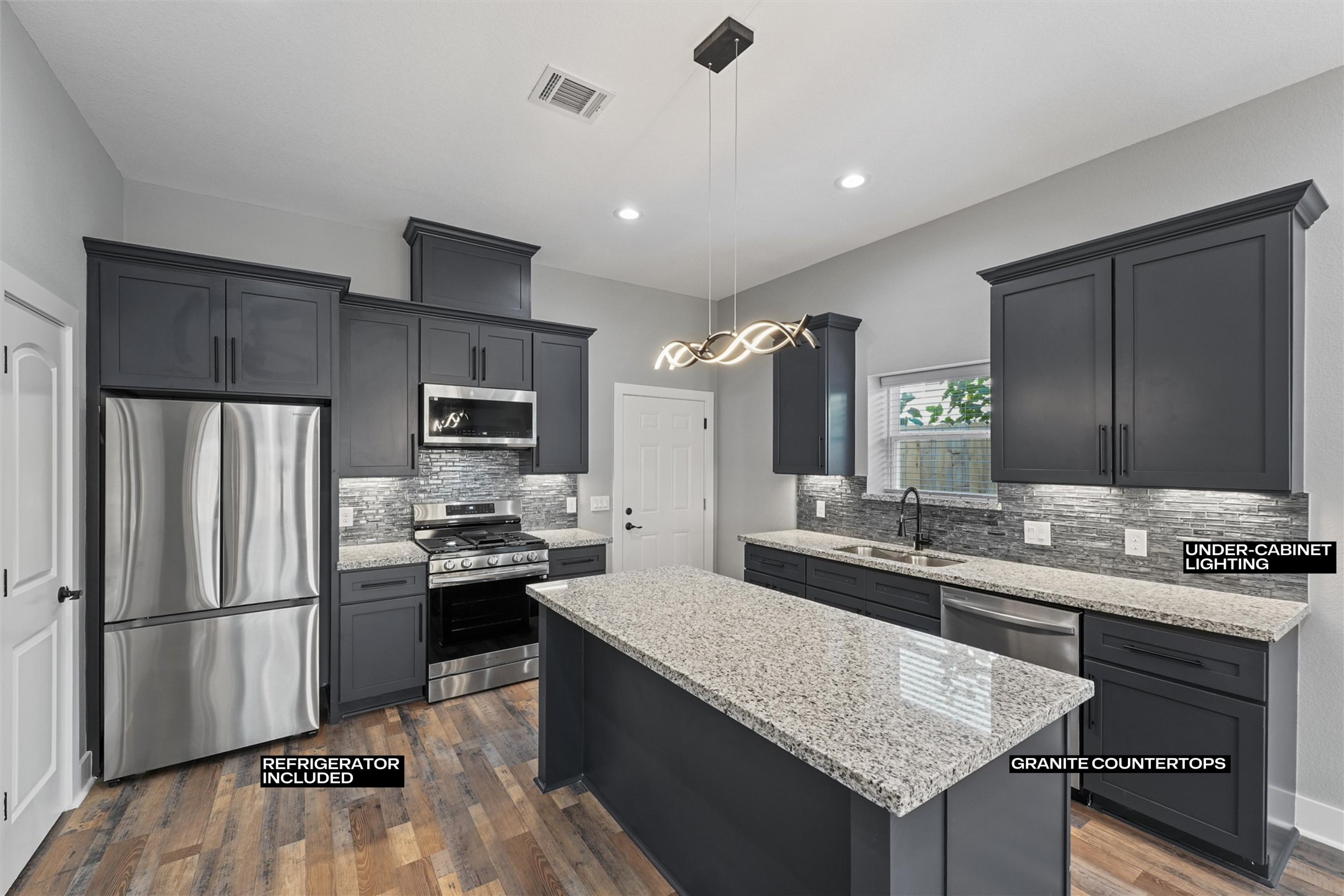 a kitchen with stainless steel appliances granite countertop a sink stove and refrigerator
