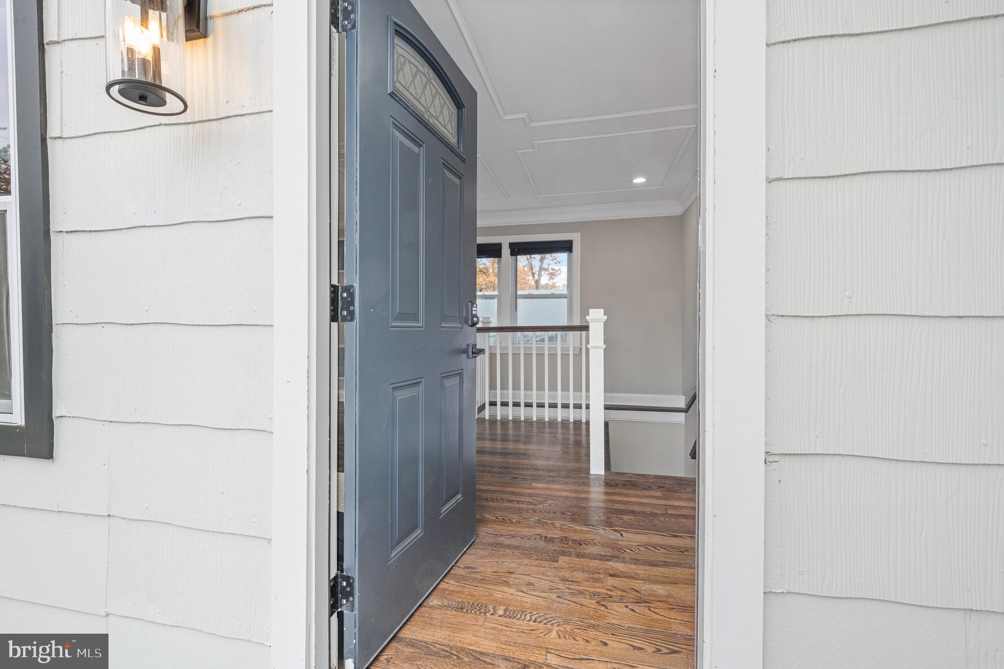 9217 Fowler Lane Lanham, MD 20706 - Photo 3 of 80 a view of a hallway with wooden floor and glass door