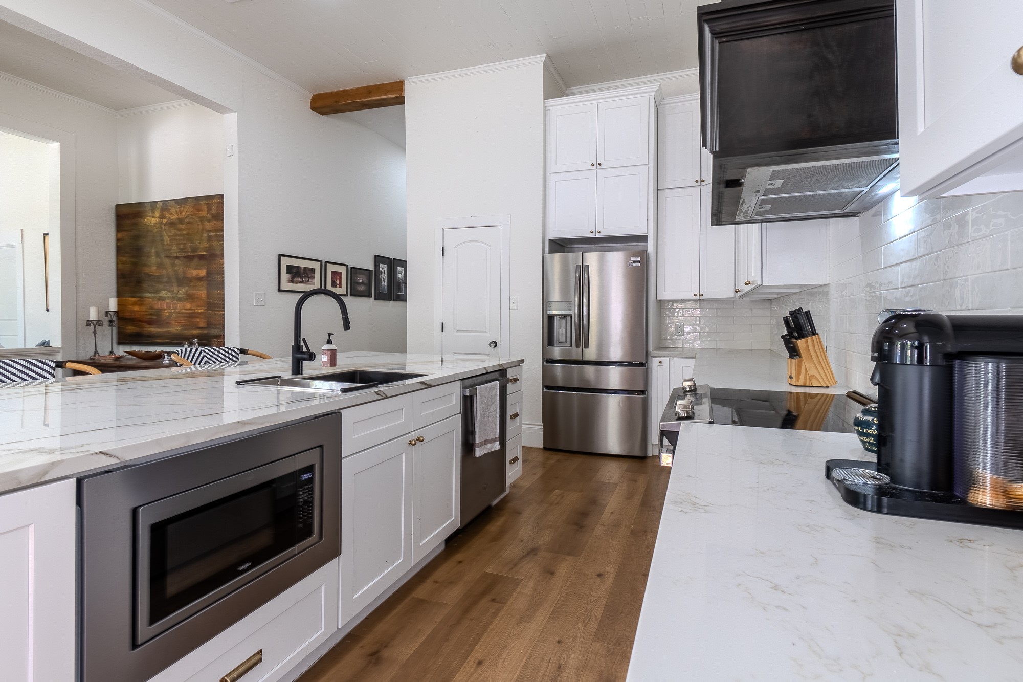 705 West 5th Street Brenham, TX 77833 - Photo 12 of 35 a kitchen with stainless steel appliances a refrigerator sink and microwave