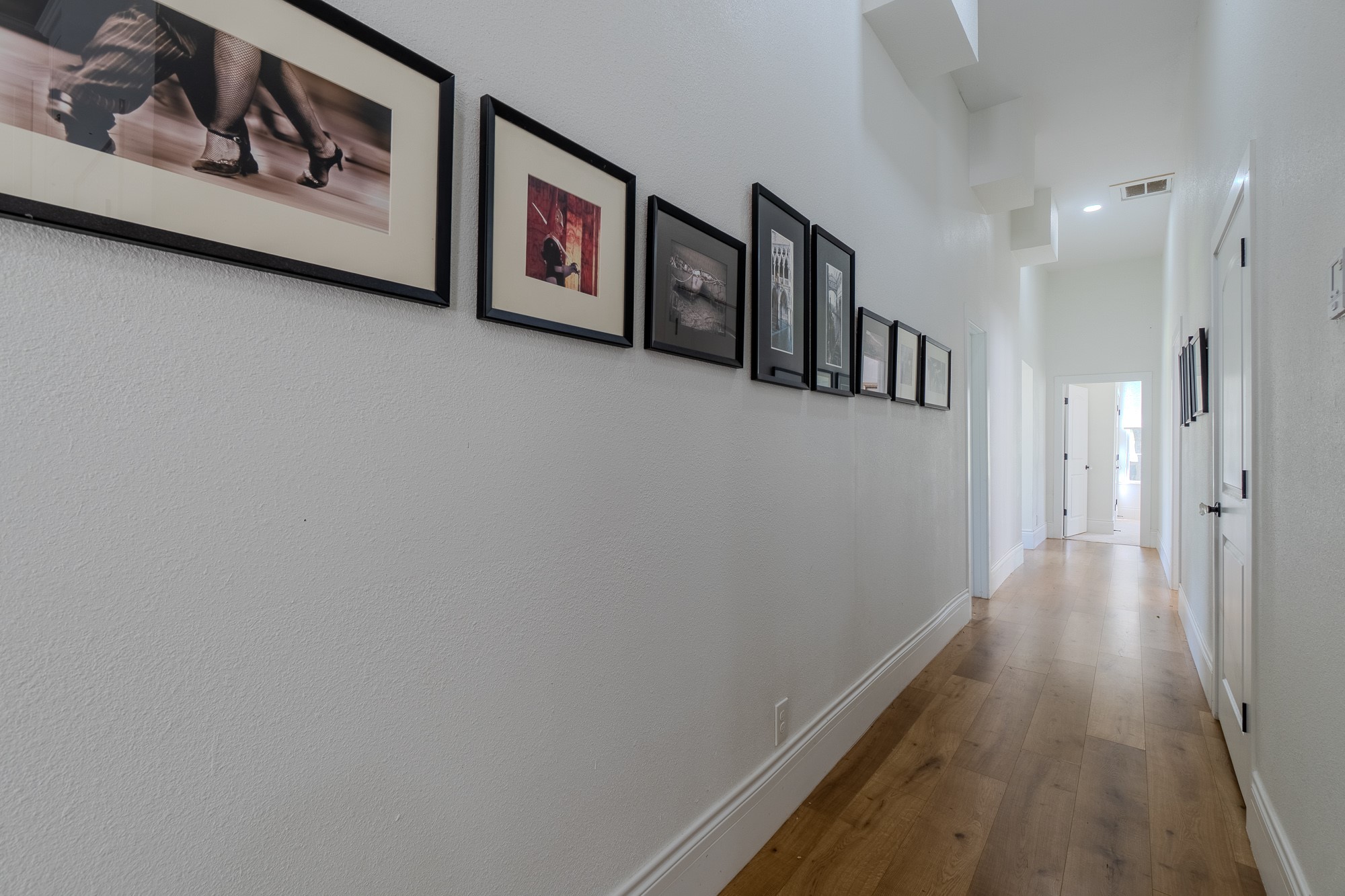 705 West 5th Street Brenham, TX 77833 - Photo 18 of 35 a view of a hallway with paintings on the wall
