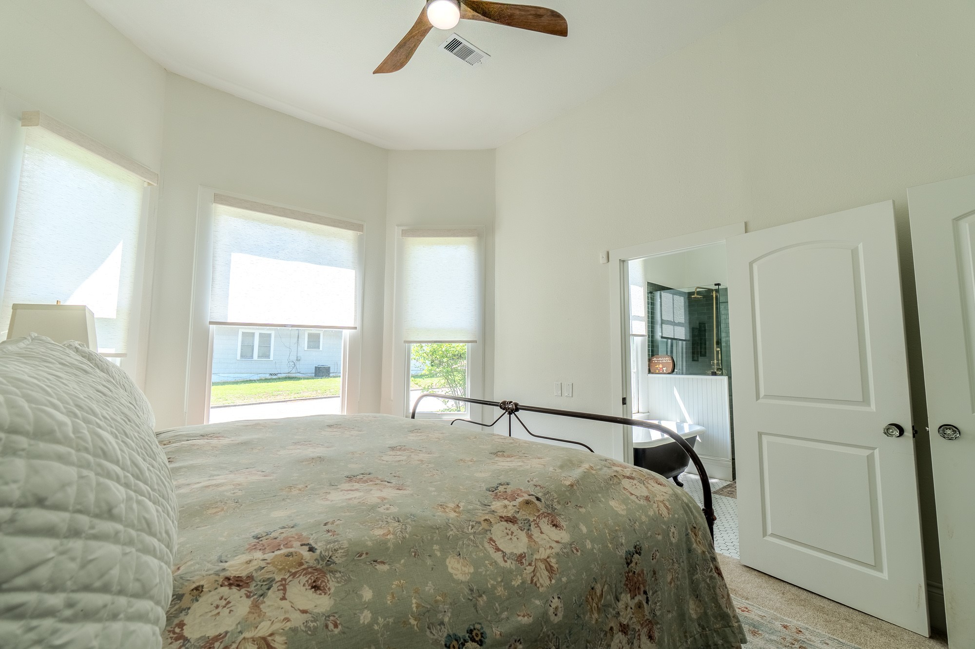 705 West 5th Street Brenham, TX 77833 - Photo 20 of 35 a bed sitting in a spacious bedroom next to a window