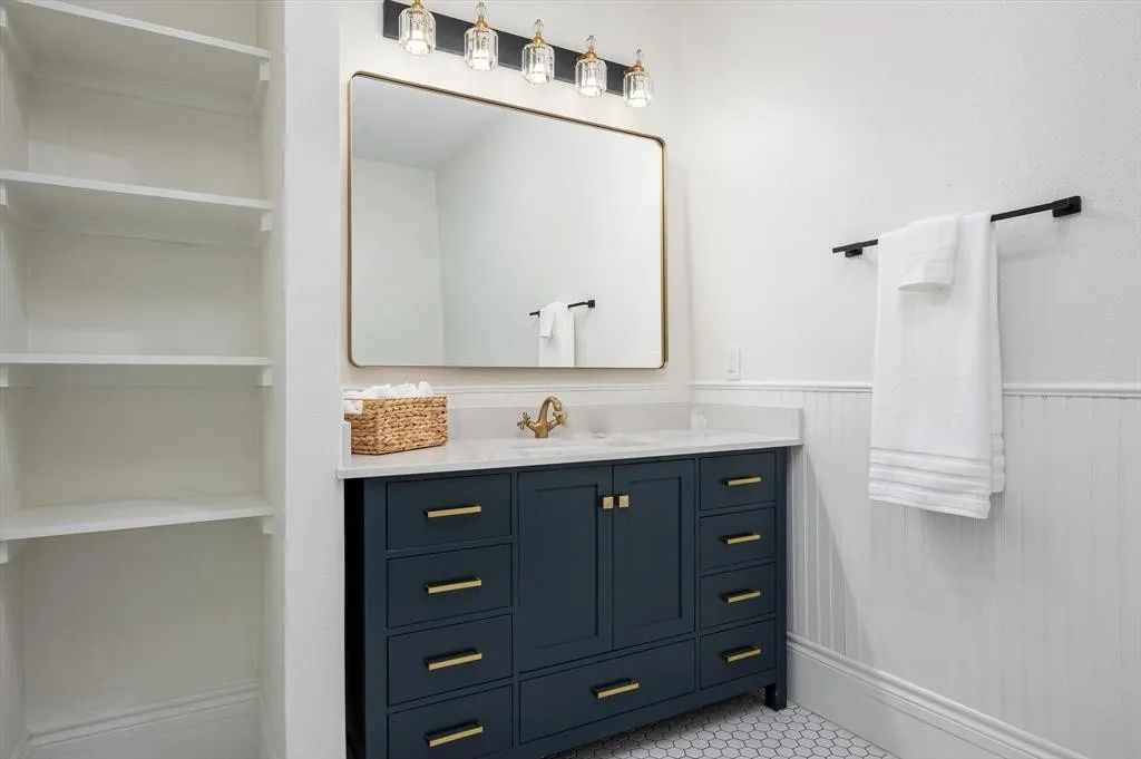 705 West 5th Street Brenham, TX 77833 - Photo 27 of 35 a bathroom with a sink vanity and mirror