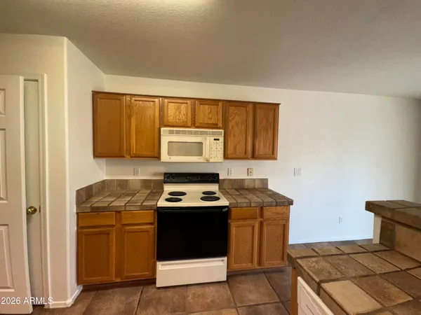 a kitchen with a stove a sink and a cabinets