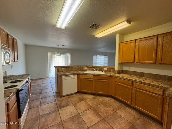 a kitchen with a stove a sink and a refrigerator