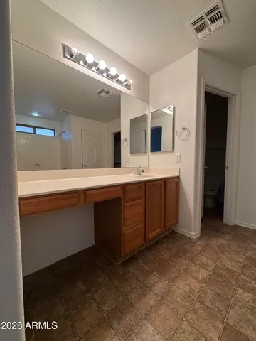 a spacious bathroom with a double vanity sink and a mirror