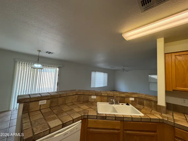 a kitchen with a sink and a stove top oven
