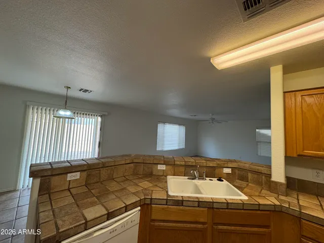 a kitchen with a sink and a stove top oven
