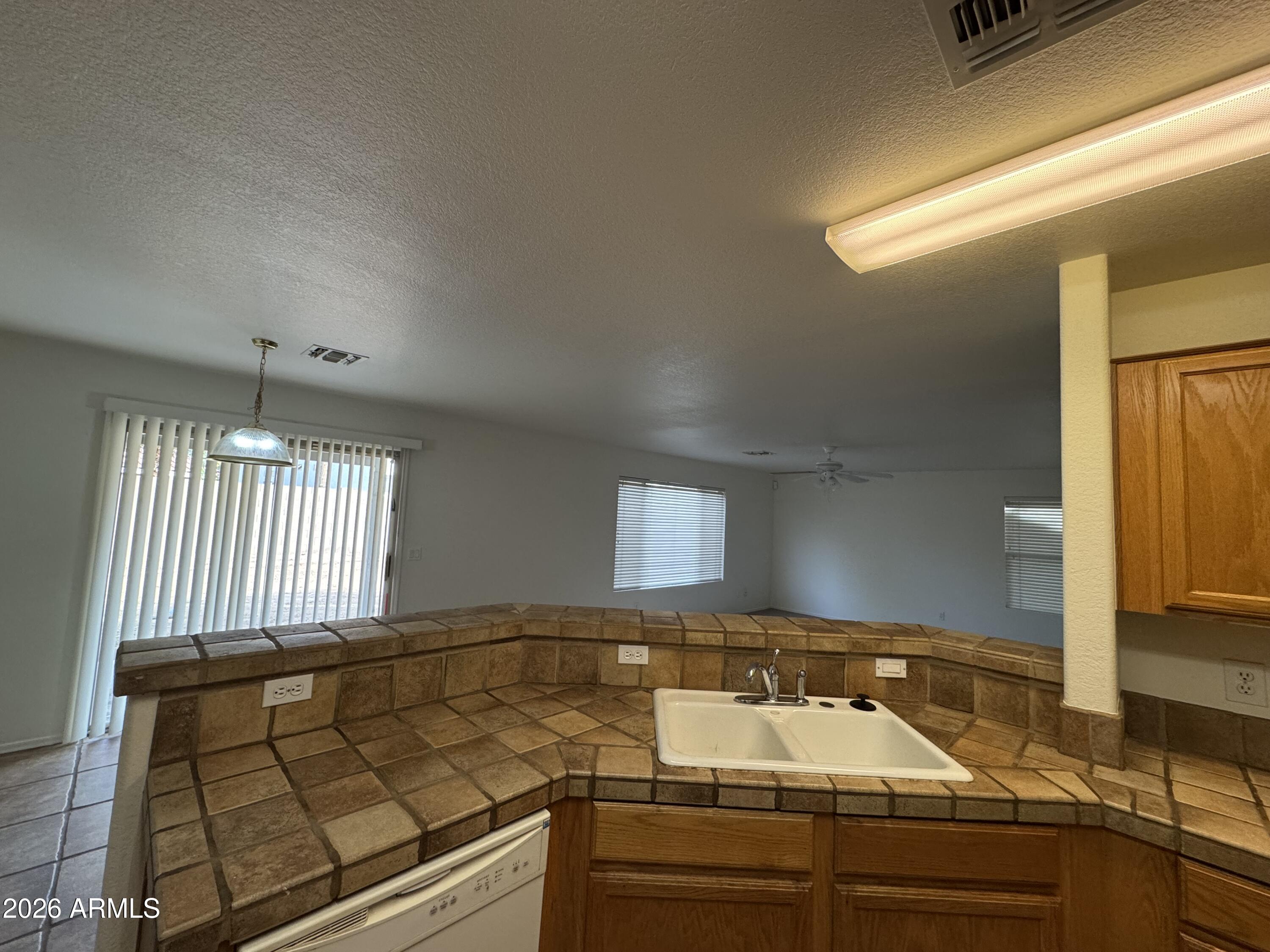 1126 East Shannon Street Gilbert, AZ 85295 - Photo 2 of 22 a kitchen with a sink and a stove top oven