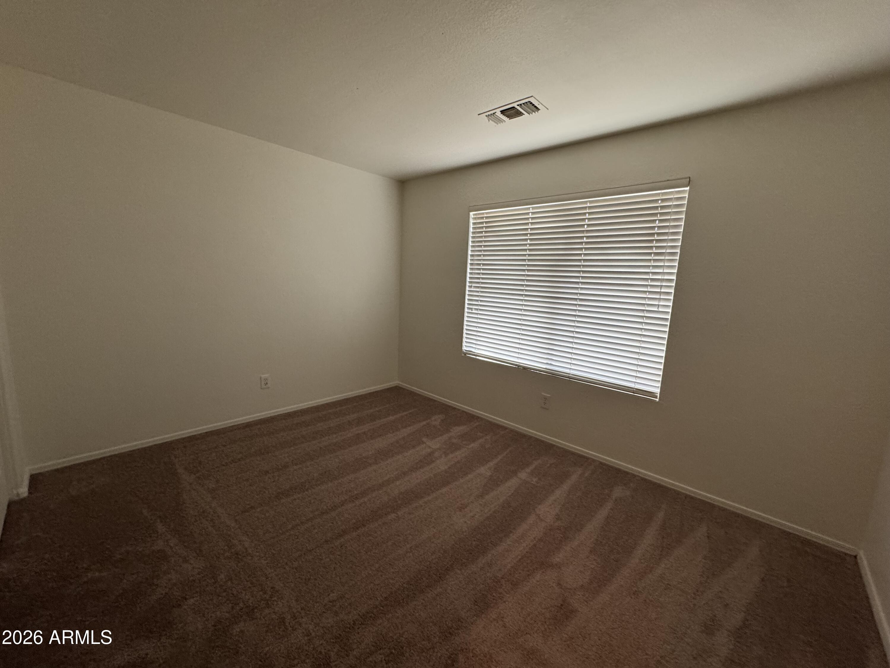 1126 East Shannon Street Gilbert, AZ 85295 - Photo 21 of 22 a view of an empty room with wooden floor and a window