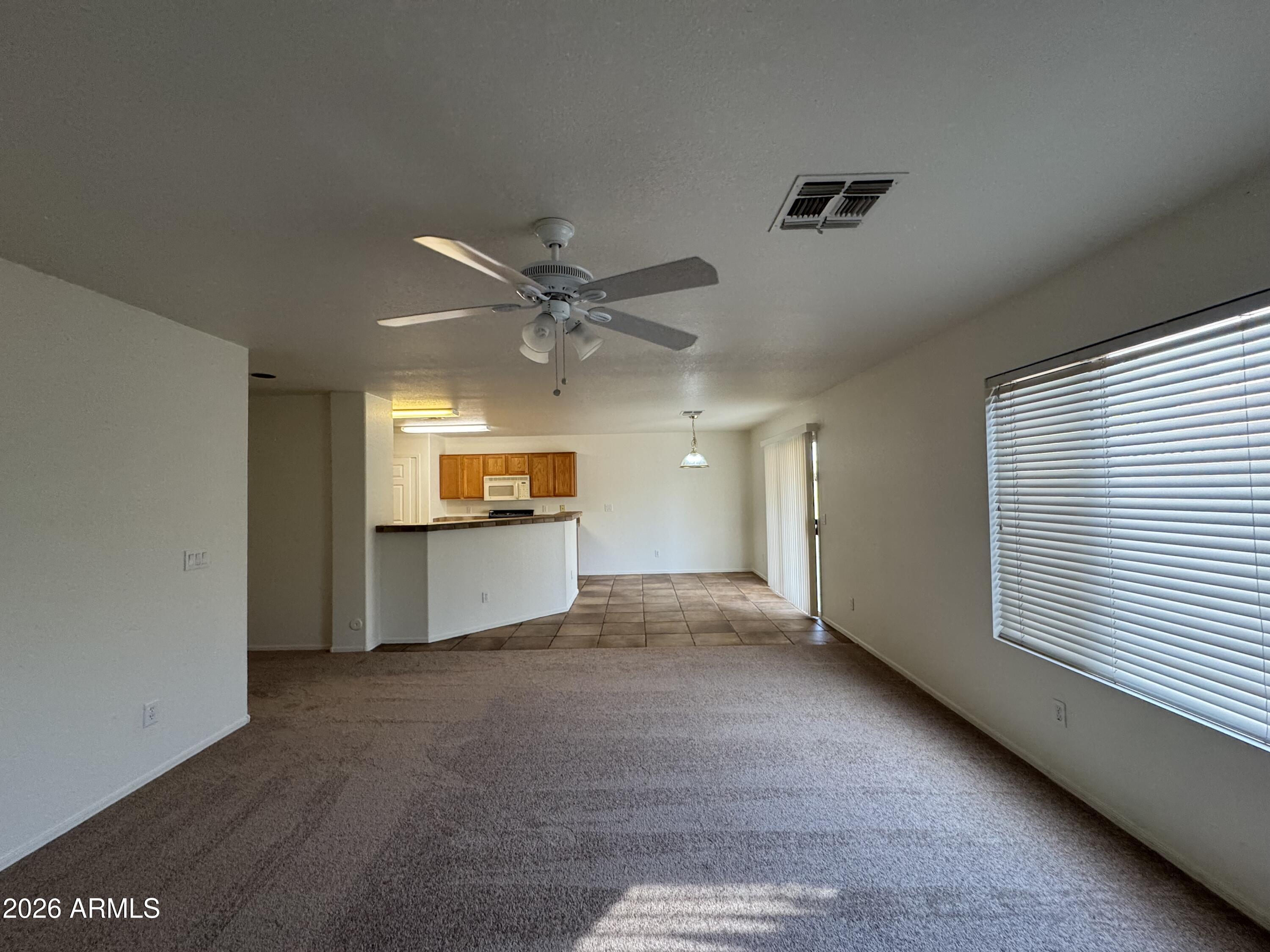 1126 East Shannon Street Gilbert, AZ 85295 - Photo 5 of 22 a view of a livingroom with a ceiling fan and window