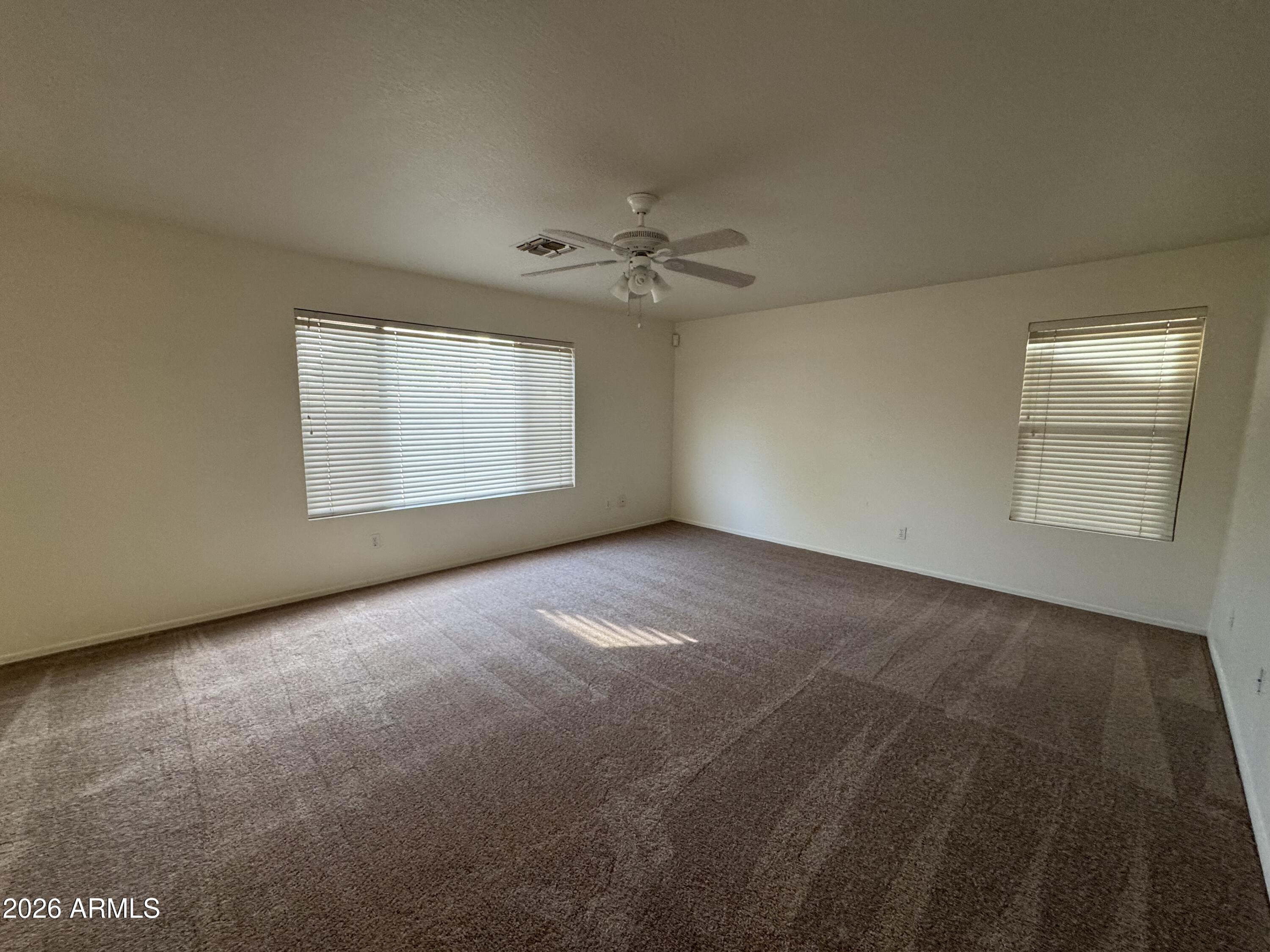 1126 East Shannon Street Gilbert, AZ 85295 - Photo 6 of 22 an empty room with windows and ceiling fan