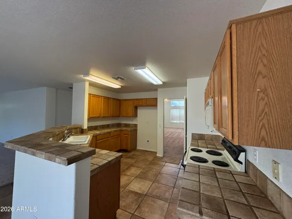 a kitchen that has a sink and a stove top oven