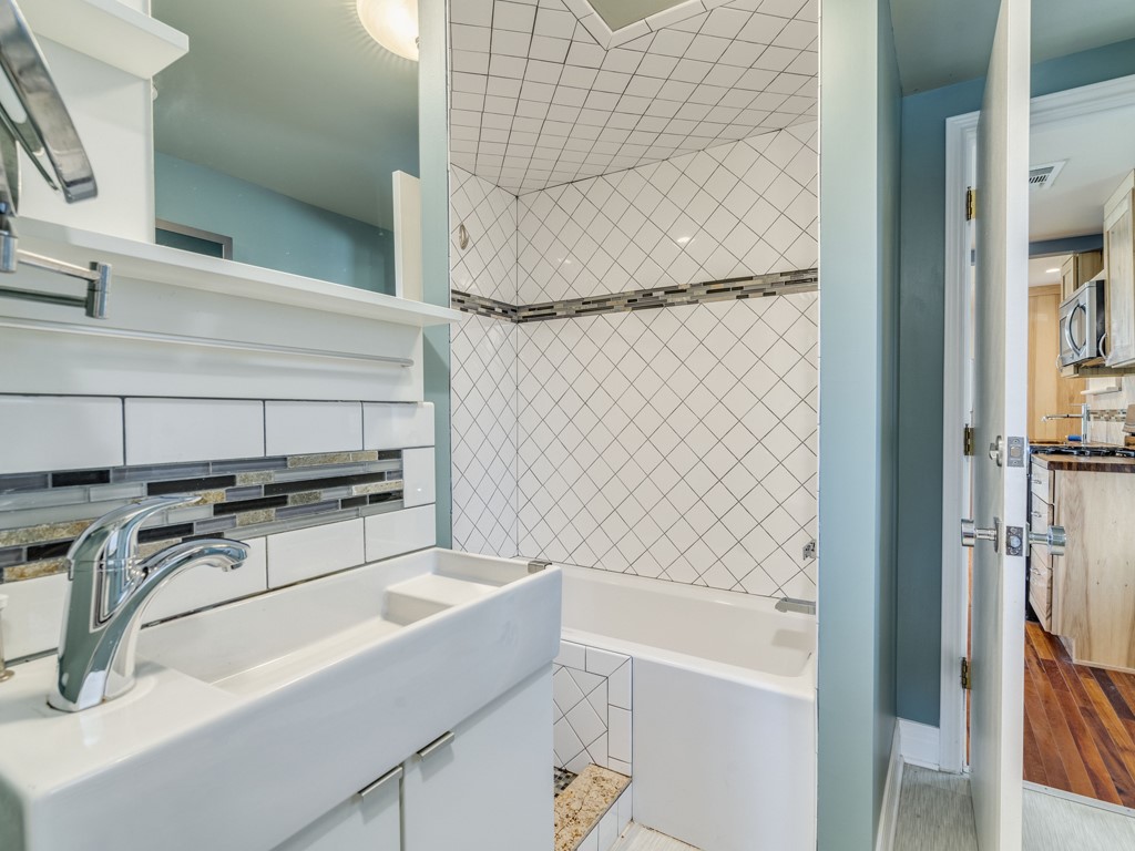 2314 Santa Rosa Street Austin, TX 78702 - Photo 11 of 27 Full bath featuring vanity, tub / shower combination, and tasteful backsplash