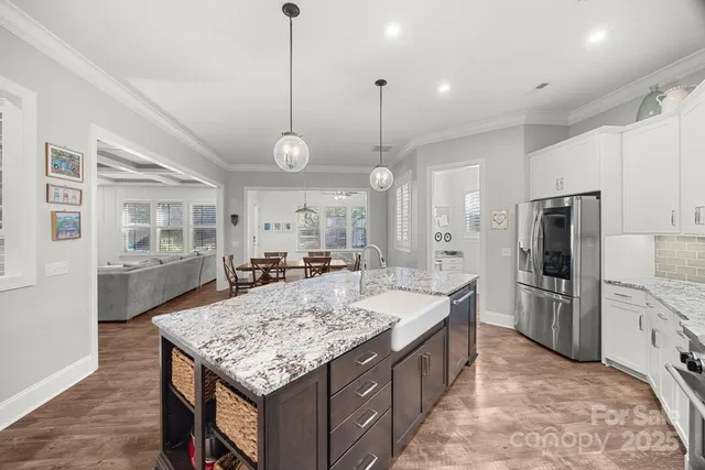 a large kitchen with kitchen island a sink stove and refrigerator