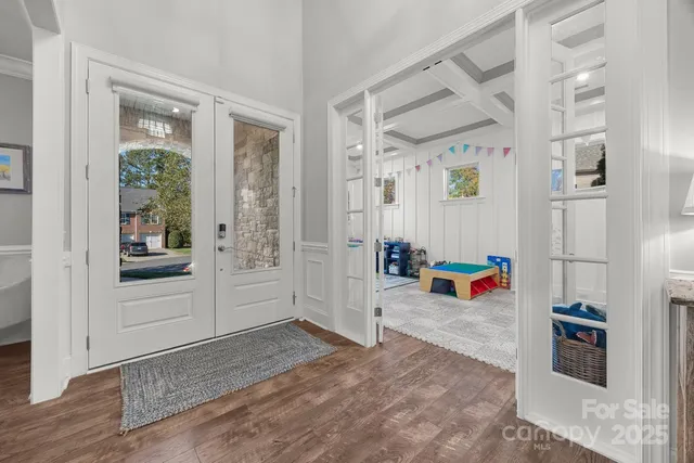 a view of a livingroom with wooden floor and windows