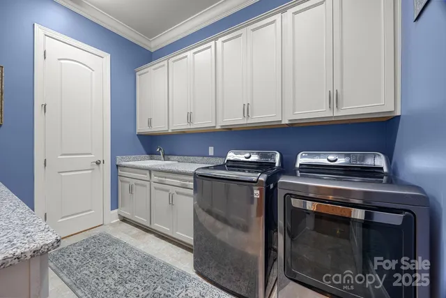 a kitchen with granite countertop white cabinets and stainless steel appliances