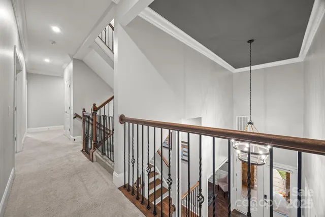 a spacious bedroom with a bed and a flat screen tv