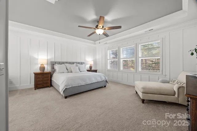 a bathroom with a granite countertop double vanity sink and mirror