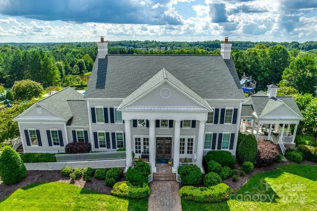 a view of backyard of the house with seating space