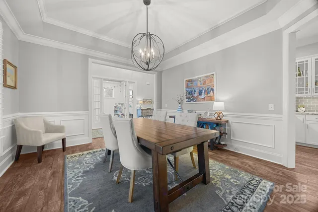 a view of a dining room with furniture wooden floor and chandelier