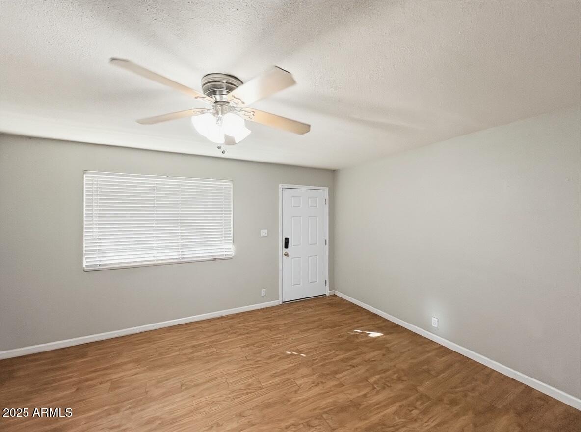 1366 West 15th Street Tempe, AZ 85281 - Photo 2 of 14 a view of a room with a ceiling fan and a window