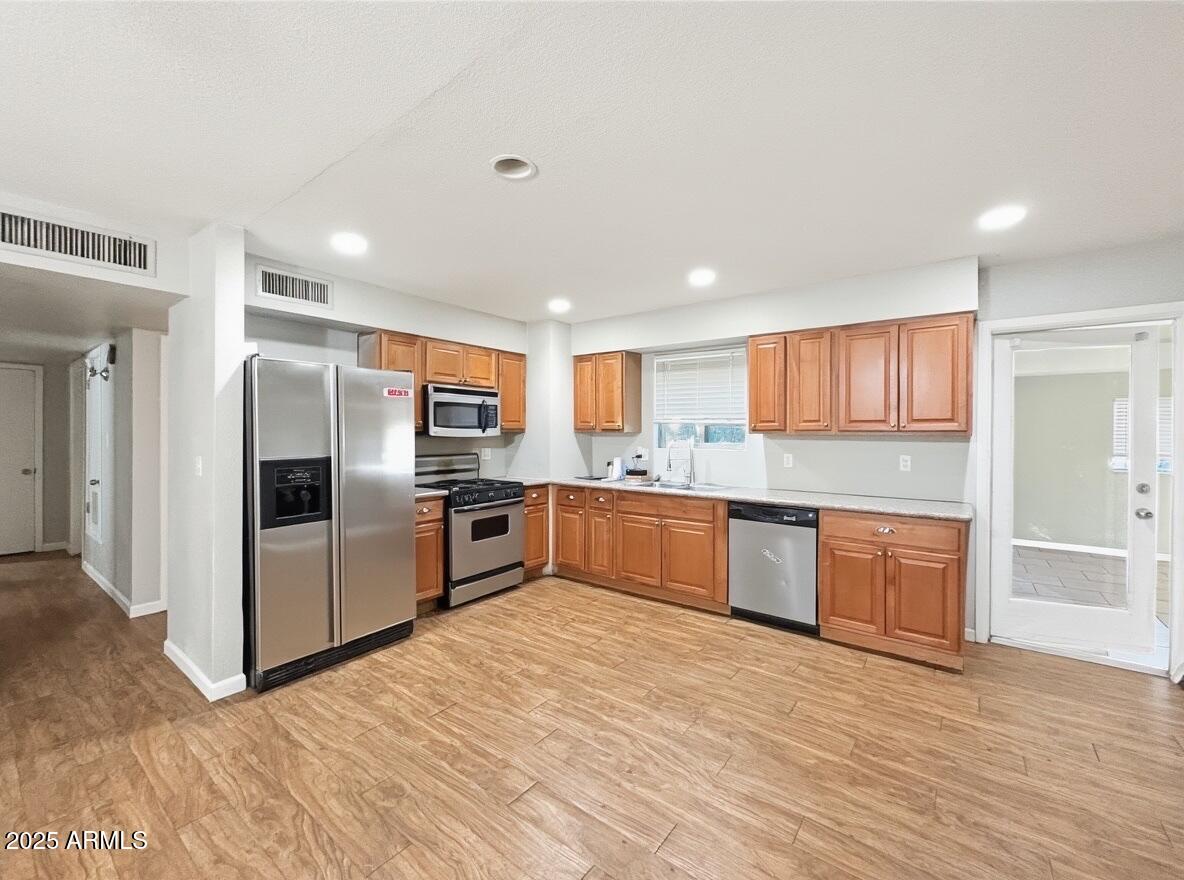 1366 West 15th Street Tempe, AZ 85281 - Photo 3 of 14 a kitchen with stainless steel appliances granite countertop a refrigerator and a stove top oven