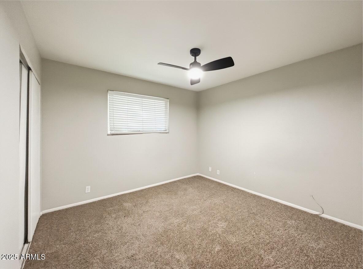 1366 West 15th Street Tempe, AZ 85281 - Photo 6 of 14 an empty room with a window and a fan
