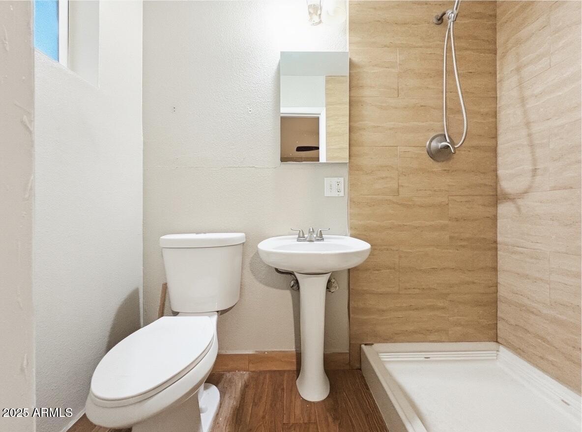 1366 West 15th Street Tempe, AZ 85281 - Photo 7 of 14 a bathroom with a sink a toilet and shower