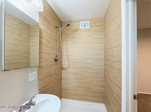 a bathroom with a shower and toilet