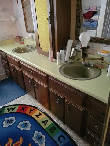 a white toilet sitting next to a wooden cabinet