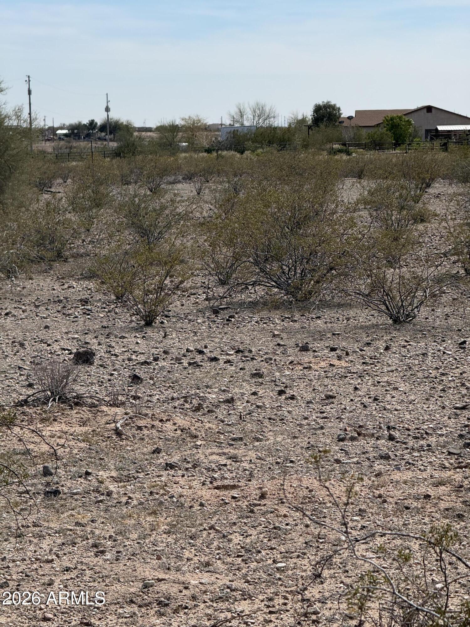29999 West Peak View Road, Unit 15 Wittmann, AZ 85361 - Photo 19 of 20 a view of a dry yard with trees