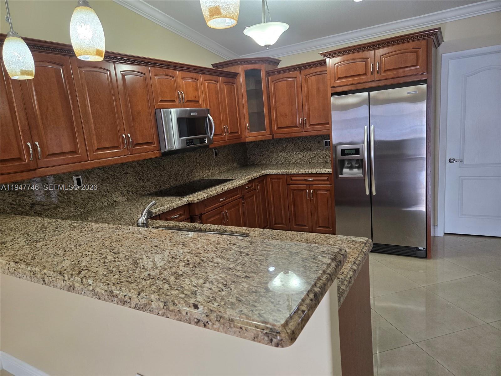 2749 West 73rd Place Hialeah, FL 33016 - Photo 12 of 15 a kitchen with a sink a counter top space cabinets and stainless steel appliances