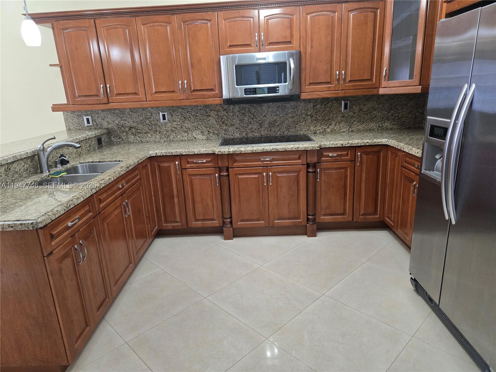 2749 West 73rd Place Hialeah, FL 33016 - Photo 13 of 15 a kitchen with stainless steel appliances granite countertop a sink stove and cabinets