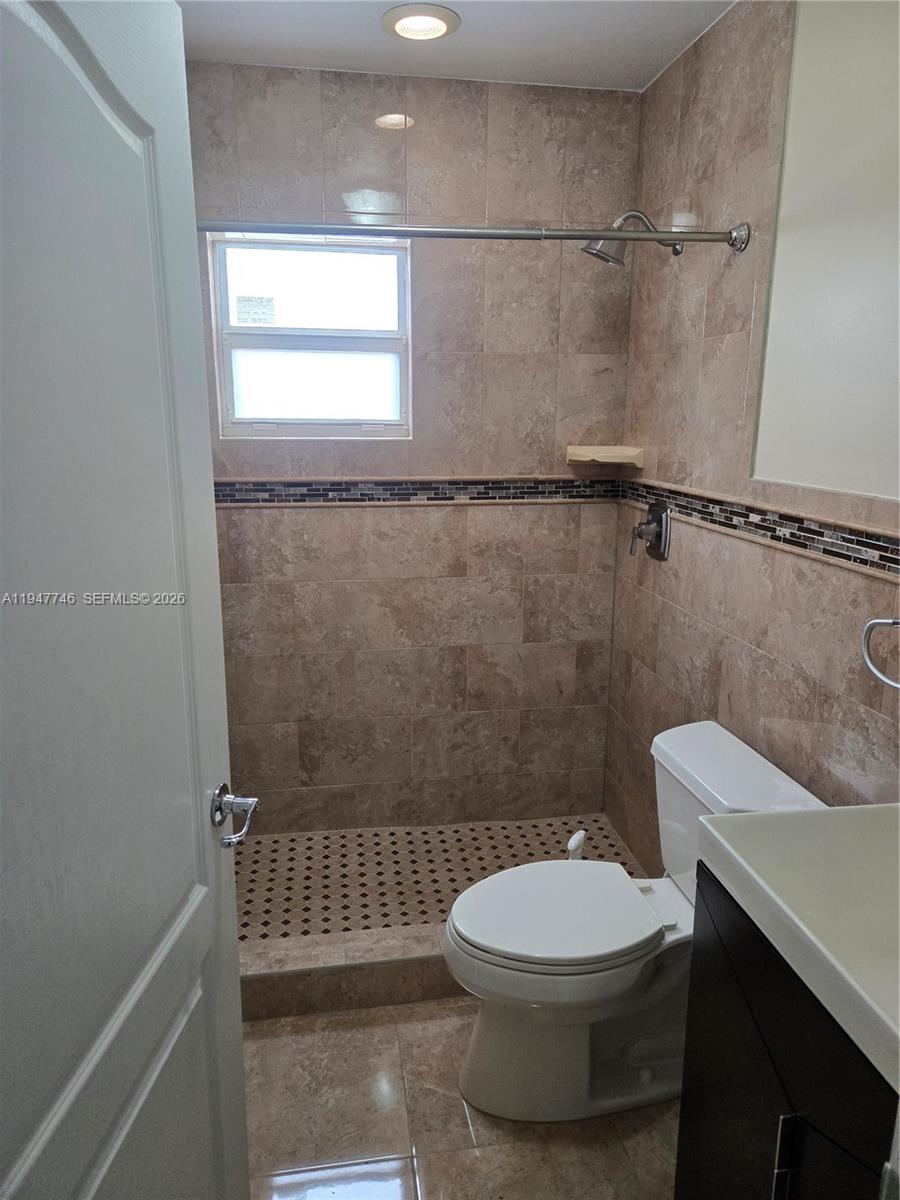 2749 West 73rd Place Hialeah, FL 33016 - Photo 14 of 15 a bathroom with a toilet a sink and a shower