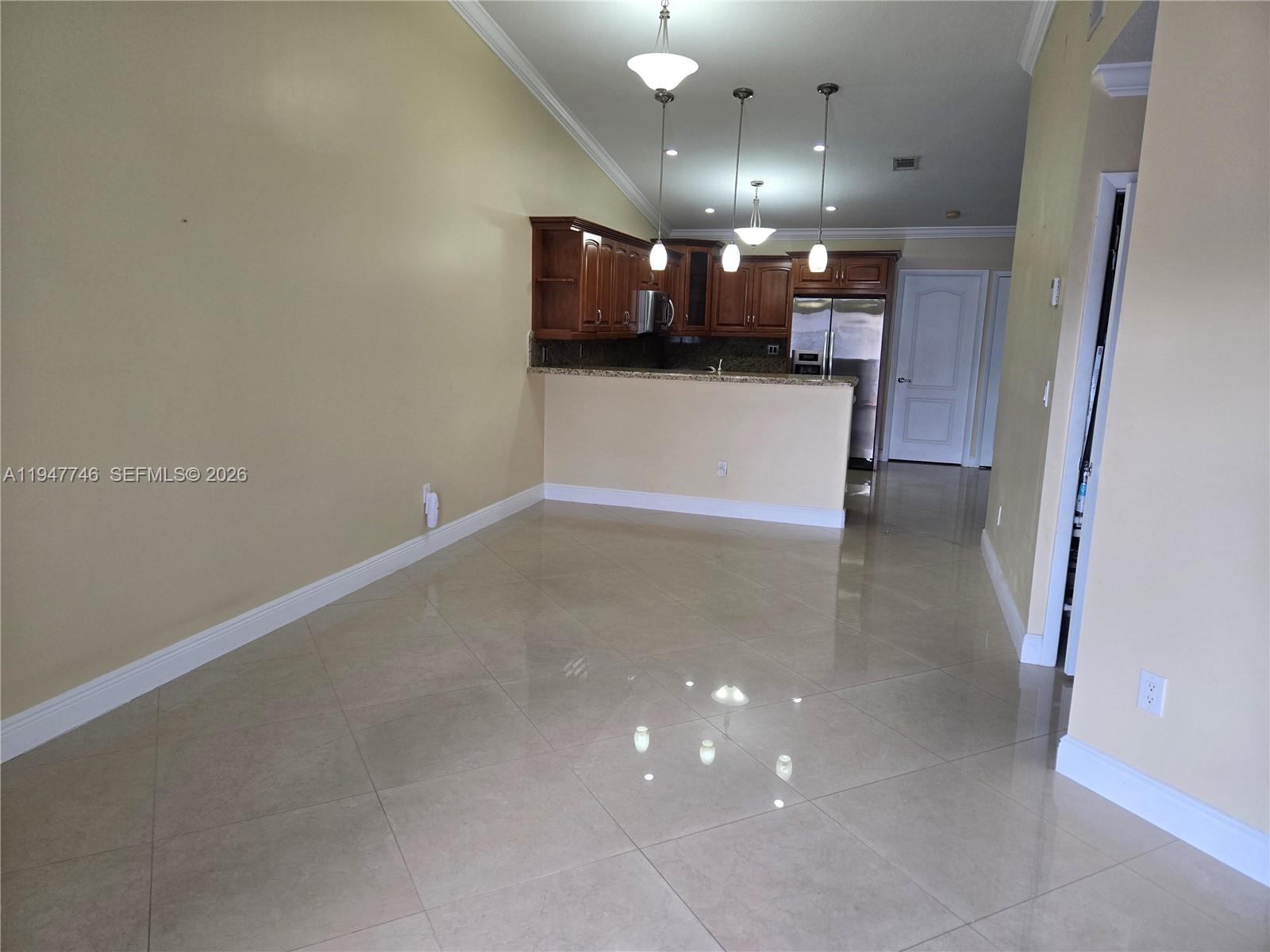 2749 West 73rd Place Hialeah, FL 33016 - Photo 5 of 15 an empty room with kitchen and windows