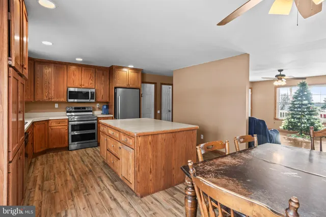 a kitchen with stainless steel appliances granite countertop a sink a stove and a refrigerator