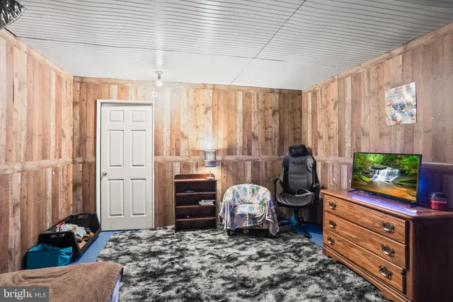 a view of a room with wooden floor and windows