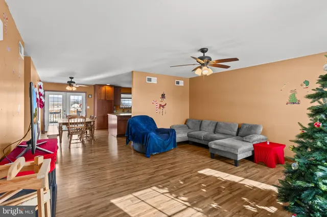 a living room with furniture and wooden floor
