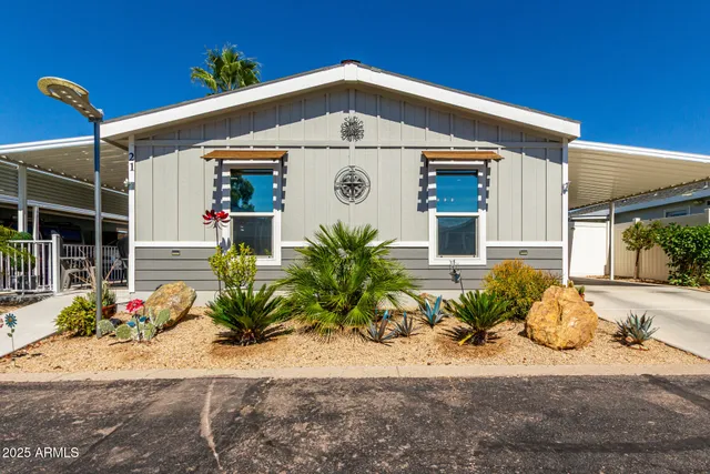 a front view of a house with plants